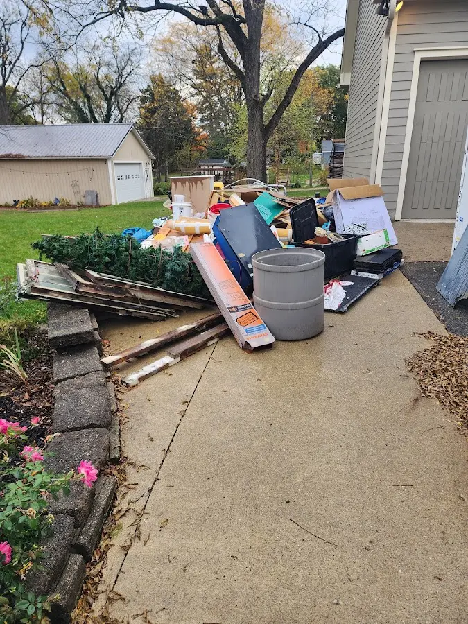 Dumpster being loaded with debris for Estate Cleanout Dumpster Rental in Pomfret